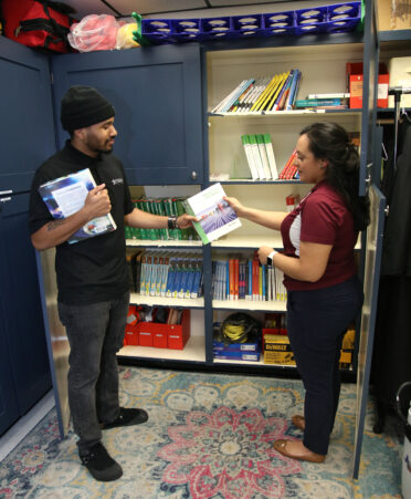 Sean Seldon (left), a TSTC Wind Energy Technology student, borrows a book from Cynthia Morley, an Advocacy and Resource Center coach at TSTC’s Harlingen campus.