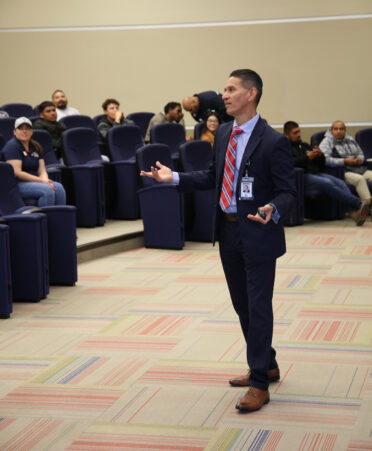 Juan Chavez (standing), vice president of leadership development and corporate compliance officer for Noble Texas Builders, speaks with TSTC Building Construction Technology students about internship opportunities during a recent employer spotlight at TSTC.