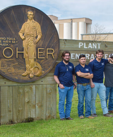 group of men in front of sign