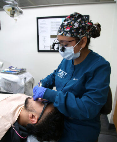 Vanessa Serrata (right), a TSTC Dental Hygiene student, practices cleaning teeth on her brother, Victor Serrata, as part of the hands-on training curriculum at TSTC’s Harlingen location.