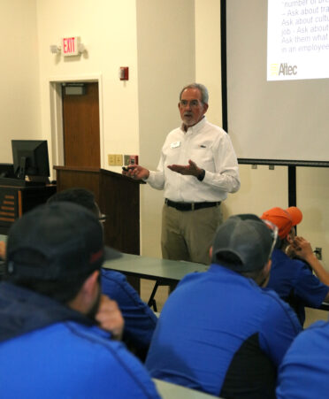 John Sherman (standing), manager for Altec Inc., speaks with TSTC Automotive Technology and Wind Energy Technology students about available job opportunities during a recent employer spotlight at TSTC’s Harlingen location.