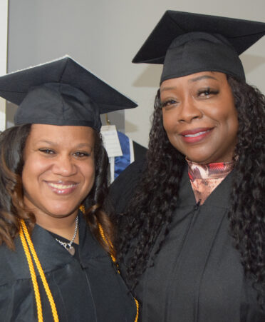 Two women in caps and gowns