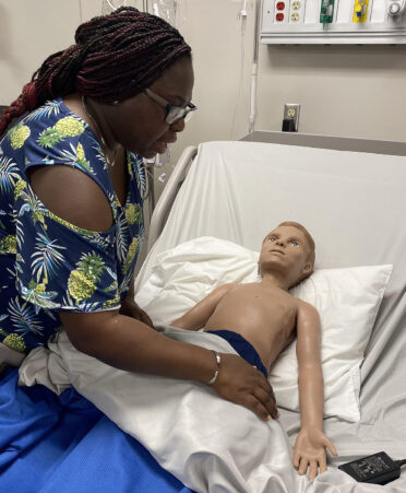 nurse working with medical manikin