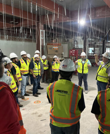Tim Ledwig, senior superintendent at Joeris General Contractors (standing at right, facing left), speaks with Building Construction Technology students from TSTC’s Harlingen campus during a recent tour of the Joeris General Contractors headquarters in San Antonio.