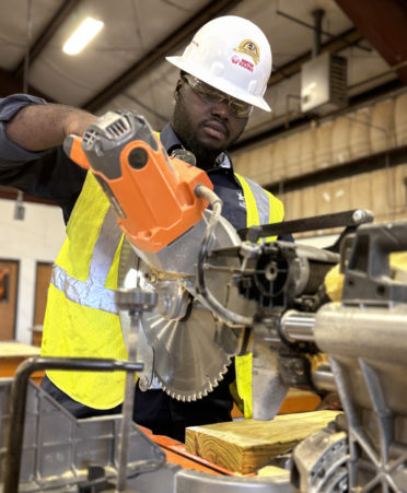 Keion Orr, a Building Construction Technology student at TSTC’s Harlingen campus, prepares to cut wood with a table saw during a recent lab session.