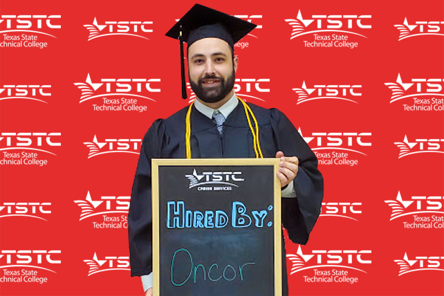 TSTC graduate posing in cap & gown holding a chalkboard showcasing their new employer.