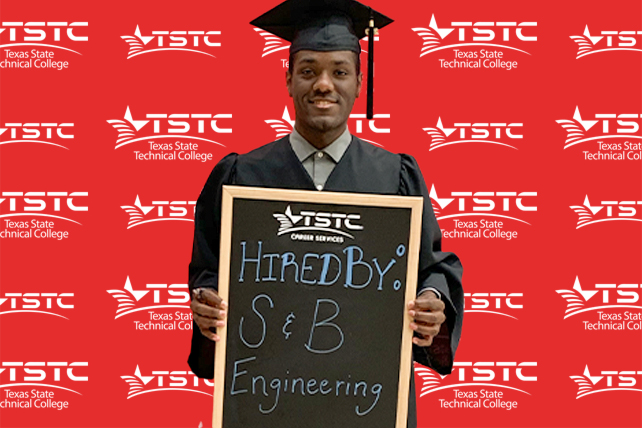 TSTC graduate posing in cap & gown holding a chalkboard showcasing their new employer.