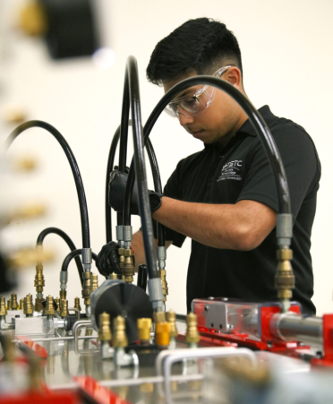 Max Cienfuegos, a TSTC Mechatronics Technology student, prepares to monitor for the pressure and flow of fluid in a hydraulic speed-control circuit during a recent lab session.