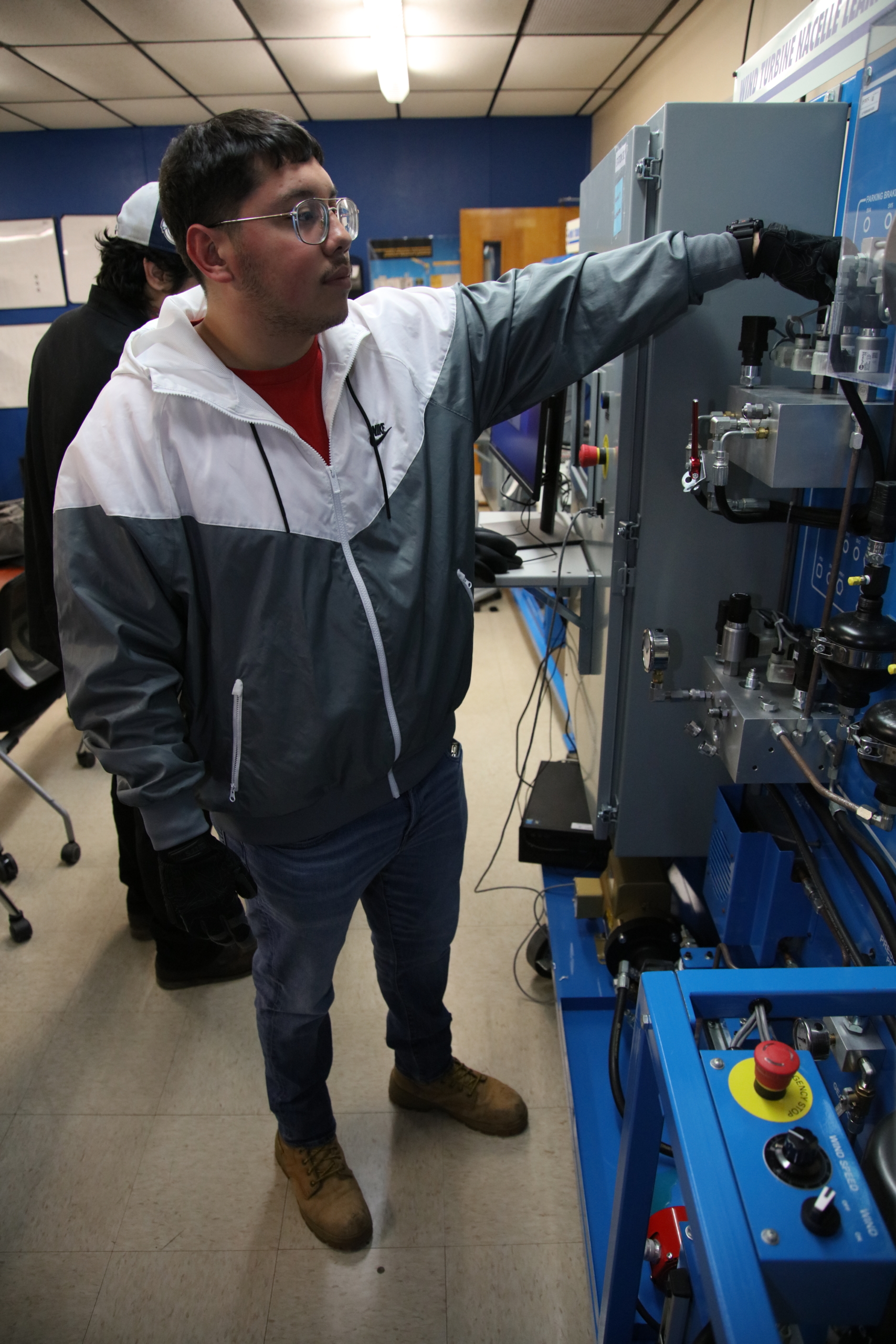 Angel Castillo, a TSTC Wind Energy Technology student, checks a motor lock to make sure that the hydraulic system is operational during a recent lab session.