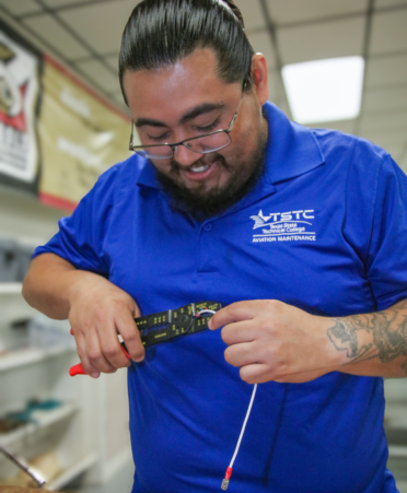 Timothy Aguirre, a TSTC Aircraft Airframe Technology student, practices connecting a wire terminal during a recent lab session.