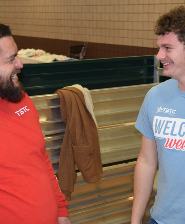 two men in tshirts talking