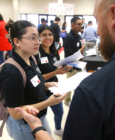 Judy Longoria (left) and Angela Salazar (center), TSTC Mechatronics Technology students, visited with Taylor Hudgeons, a maintenance superintendent for NextDecade, at the Spring 2025 Industry Job Fair at TSTC’s Harlingen campus.