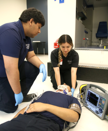 TSTC Emergency Medical Services students Hector Jalomo (left) and Destiny Trevino (right) practice a trauma scenario on classmate Samuel Orozco with an iSimulate REALITi 360 monitor simulator during a recent lab session at TSTC’s Harlingen campus.