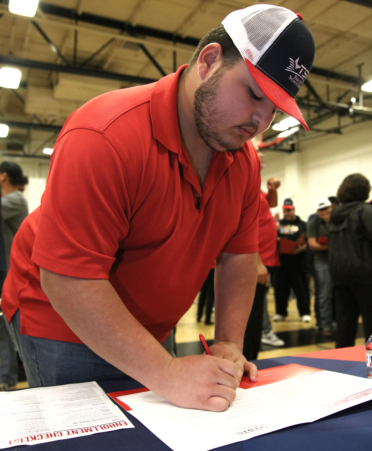 Jesus Contreras, a senior from San Benito High School, shows his TSTC pride after signing his letter of intent to pursue the Diesel Equipment Technology program at TSTC during the recent NC3 National CTE Letter of Intent Signing Day at TSTC’s Harlingen campus.