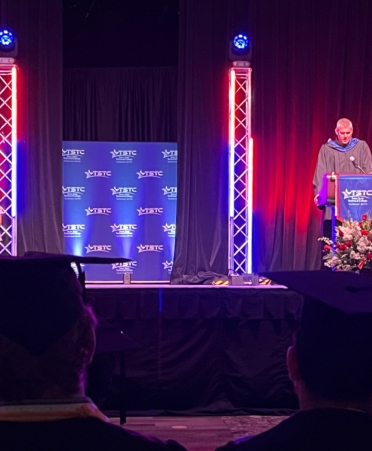 Texas State Technical College’s North Texas campus held its Spring 2025 Commencement on Monday, April 28, at the Waxahachie Civic Center. Provost Marcus Balch is shown here addressing the graduates from the podium. (Photo courtesy of TSTC.)