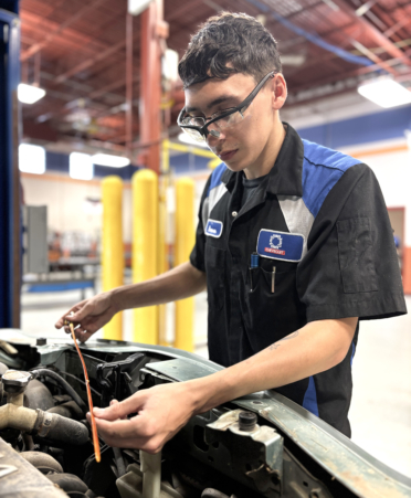 Aaron Munoz, an Automotive Technology student at TSTC’s Harlingen campus, checks the oil level on a dipstick during a recent lab session.