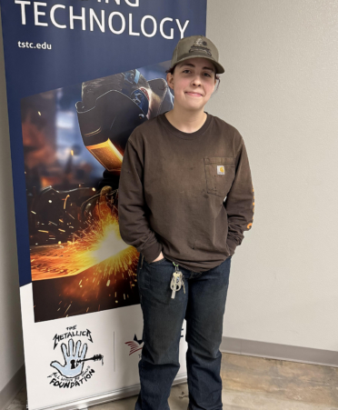 female in brown shirt and hat