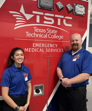 two emts in front of an ambulance