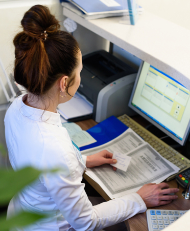 Female receptionist working the computer.