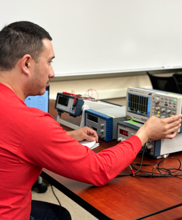 Justin Rivera, a Wind Energy Technology student at TSTC’s Harlingen campus, sets up a function generator during a recent lab session.