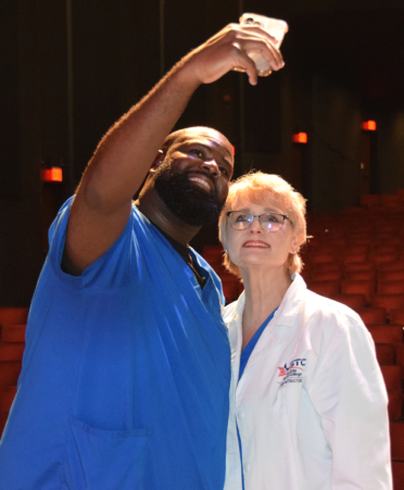 two people in scrubs taking a selfie