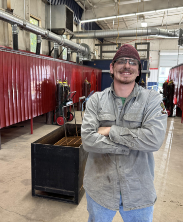 man in welding shirt inside a welding lab