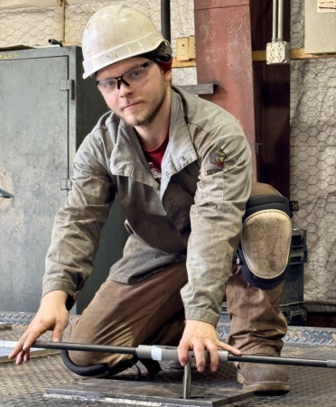 Jacob Taylor, a Welding Technology graduate from TSTC’s Marshall campus, taps holes into a skid base for nails and bolts at Warfab LLC’s Hallsville location. (Photo courtesy of TSTC.)