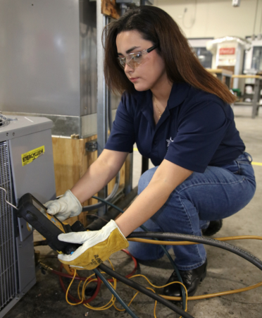 Samantha Trejo, an HVAC Technology student at TSTC’s Harlingen campus, checks the pressure on a digital gauge during a recent lab session.