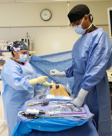 Joshua Viera, right, a Surgical Technology student at Texas State Technical College’s Harlingen campus, hands a surgical scalpel to classmate Victoria Ortega during a recent lab session.