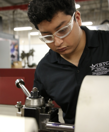 Jose Loera, a Precision Machining Technology student at Texas State Technical College’s Harlingen campus, uses a high-speed lathe to cut steel during a recent lab session.