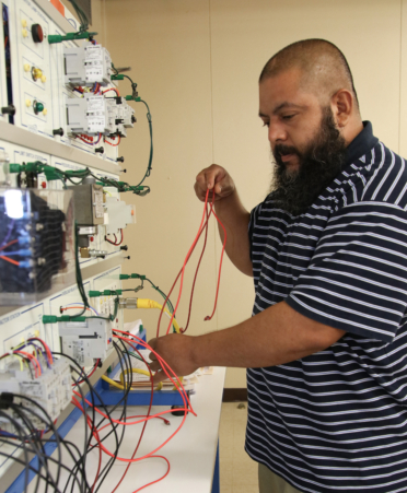 Marcelo Davila, a Wind Energy Technology student at TSTC’s Harlingen campus, works on a motor controls assignment during a recent lab session.