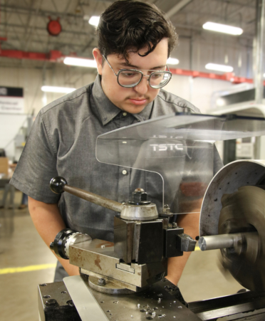 Rigoberto Almaraz, a Precision Machining student at TSTC’s Harlingen campus, uses a high-speed lathe to cut steel during a recent lab session.