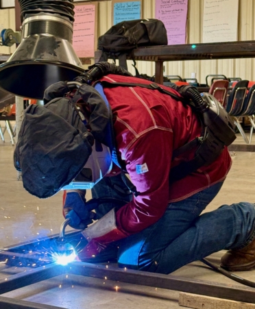 Photo caption: A Granger High School welding student uses new Miller-brand equipment while working on a bathroom stall project. (Photo courtesy of TSTC.)