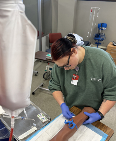 Nursing student practicing IV therapy