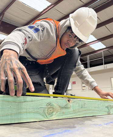 Building construction student in hardhat and safety vest