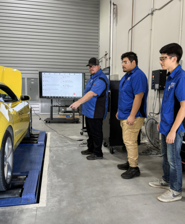 TSTC Automotive instructor Bruce Schmitt (left) demonstrates how the program’s all-wheel drive dynamometer operates to students Gustavo Melendez (center) and Santiago Castellanos.