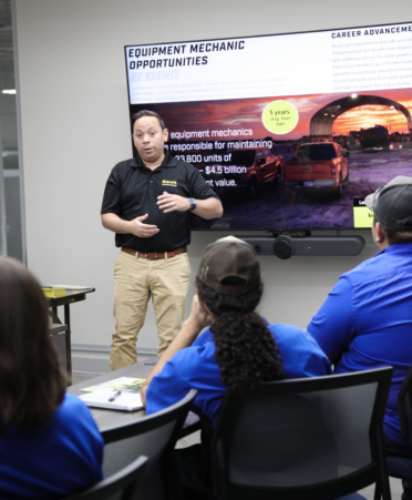2R7A9018-1 Carlos Gabriel Cambrelen (standing), workforce development manager at Kiewit Corp., speaks with TSTC Diesel Equipment students about available job opportunities during a recent employer spotlight at Texas State Technical College’s Harlingen campus.