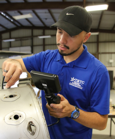 Zachary Alanis, an Aircraft Airframe student at Texas State Technical College’s Harlingen campus, inspects a section of a PT6 turbine engine during a lab session.