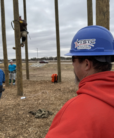 man in red sweatshirt watching class