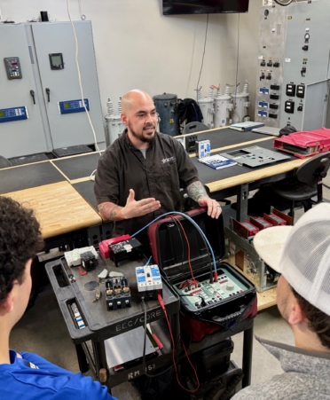 Photo caption: Ryan Delgago, center, an instructor in Texas State Technical College’s Electrical Power and Controls program, talks to visiting high school students on Friday, Feb. 6, at the Waco campus. (Photo courtesy of TSTC.)