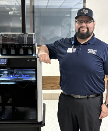 Samuel Pizano, a Drafting and Design instructor at Texas State Technical College’s Harlingen campus, stands next to the program’s new Bambu Lab H2D 3D printer.