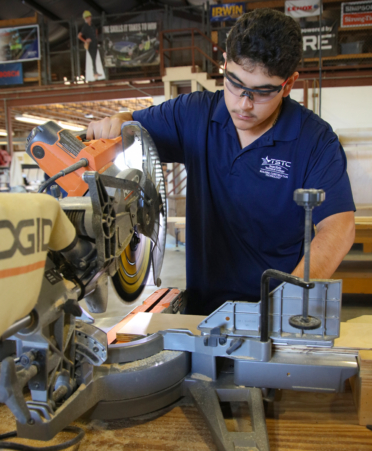 Humberto Martinez, a Building Construction student at Texas State Technical College’s Harlingen campus, prepares to cut wood with a table saw during a recent lab session. He will compete in the SkillsUSA Texas Postsecondary Leadership and Skills Conference April 8-11 in Corpus Christi.