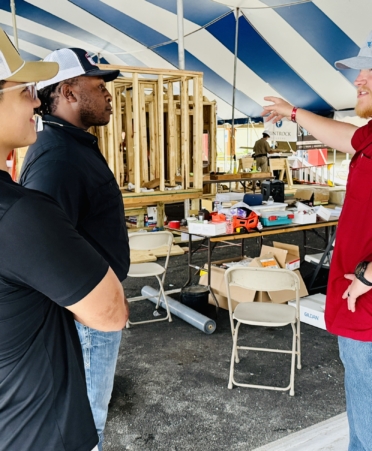 IMG_5538 Photo caption: Texas State Technical College graduates (from left) Teo Orduna, William Holmes III and Cody Scheffe discuss TeamWorks projects being built at the recent 2026 SkillsUSA Texas Postsecondary Leadership and Skills Conference in Corpus Christi. The graduates work for Rogers-O’Brien Construction. (Photo courtesy of TSTC)