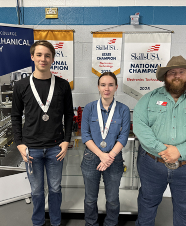 3 people standing in front of banners