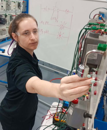Melody Jenkins, an Advanced Manufacturing - Industrial Maintenance student at Texas State Technical College’s Fort Bend County campus, connects a float switch to a control circuit during a lab session.