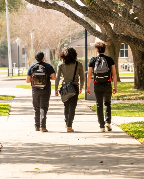 Three students walking on campus