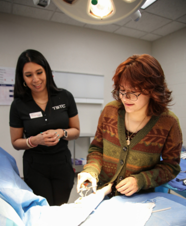 2R7A3474-2 Cassandra Ysasi (left), a Surgical Technology instructor at Texas State Technical College’s Harlingen campus, watches as Jimena Ruiz Montemayor uses a surgical instrument during an open house on Tuesday, Oct. 13.